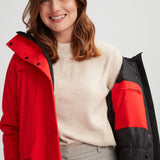 Manteau de couleur rouge feu pour femme. Tissu imperméable et respirant.